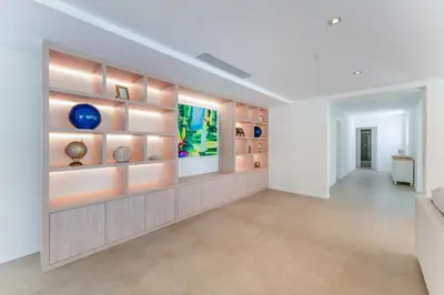 a living room with a couch and a wall with shelves at Villa Natura in Vilamoura