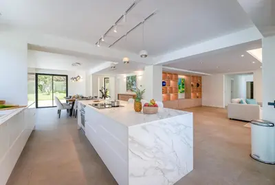 an open kitchen and living room with a large island at Villa Natura in Vilamoura
