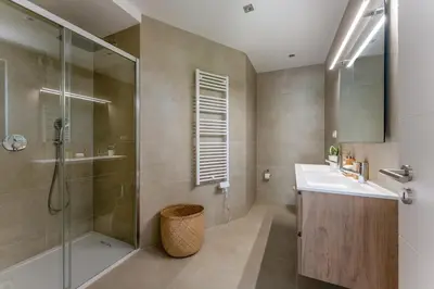 a bathroom with a glass shower and a sink at Villa Natura in Vilamoura