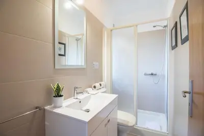 a bathroom with a white sink and a shower at Casa Clara in Vilamoura