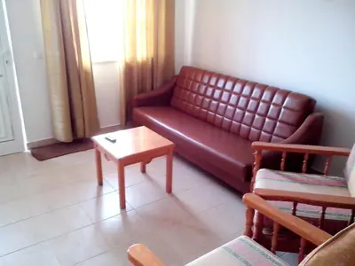 a living room with a couch and a coffee table at Charming Apartment in Albufeira with Shared Pool in Albufeira