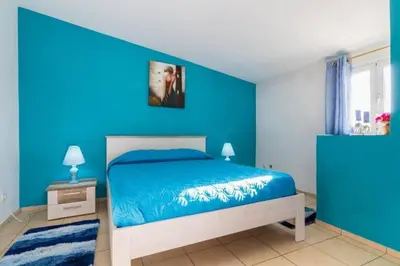 a blue bedroom with a bed and a blue wall at ★Traditional House★Heart of Oldtown★ Amazing views in Albufeira