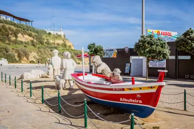 a boat on the beach with a group of people in it at ★Traditional House★Heart of Oldtown★ Amazing views in Albufeira