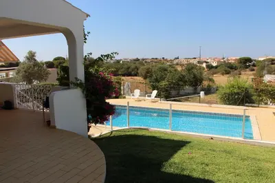 a view of a swimming pool from a house at Vivenda ROSA Albufeira in Fontainhas