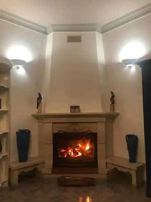 a fireplace in a living room with two lights at Vivenda ROSA Albufeira in Fontainhas