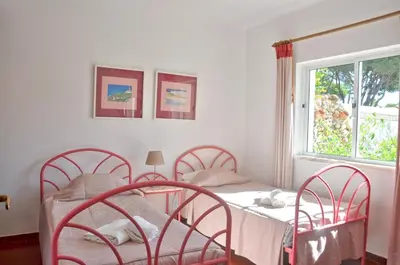 a dining room with a wooden table and chairs at Stylish well-equipped, private pool, close to amenities, free AC Wifi in Quarteira