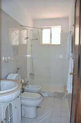 a bathroom with a toilet and a sink at Stylish well-equipped, private pool, close to amenities, free AC Wifi in Quarteira