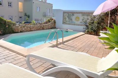 a kitchen with white appliances and a door to a patio at Stylish well-equipped, private pool, close to amenities, free AC Wifi in Quarteira