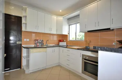 a brick patio with a white wall and a chair at Delightful single-storey villa, private pool, free air conditioning and wifi in Vilamoura