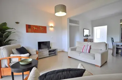 a kitchen with white cabinets and a sink and a window at Delightful single-storey villa, private pool, free air conditioning and wifi in Vilamoura