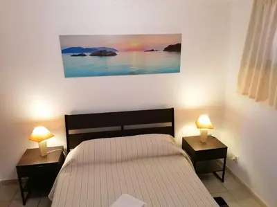 a bedroom with a bed and two night stands with lamps at Oceana in Faro