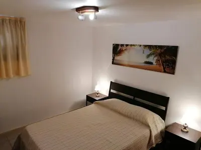 a bedroom with a bed and two nightstands and two lamps at Oceana in Faro