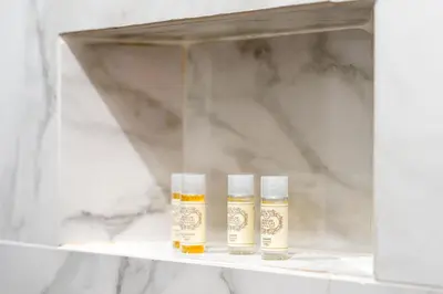 three bottles of essential oils sitting on a shelf at Downtown Lux Apartment in Faro