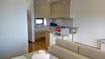 a kitchen with a couch and a counter in a room at Sea View5 in Albufeira