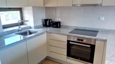 a kitchen with a sink and a stove top oven at Sea View5 in Albufeira