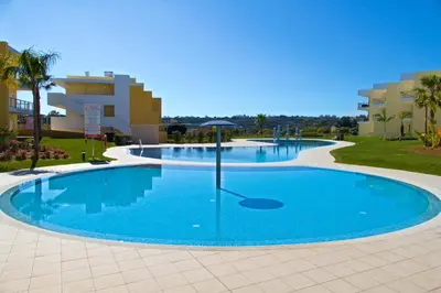 a large pool with blue water in a resort at Albufeira Premium Apartment in Albufeira
