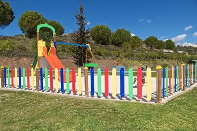 a colorful wooden fence in a park with a playground at Albufeira Premium Apartment in Albufeira