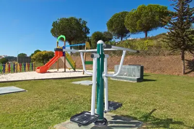 a park with a playground with a swing at Albufeira Premium Apartment in Albufeira