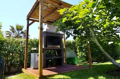 a gazebo in a yard with a tree at Villa Bellevue in Albufeira