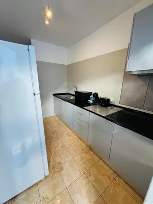 a kitchen with black counter tops in a room at Apartment old town MFA in Albufeira