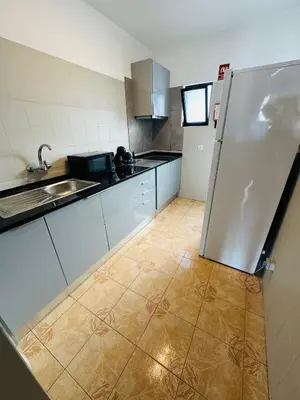 a kitchen with a refrigerator and a tile floor at Apartment old town MFA in Albufeira