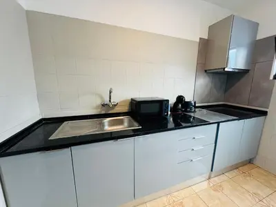 a small kitchen with a sink and a microwave at Apartment old town MFA in Albufeira
