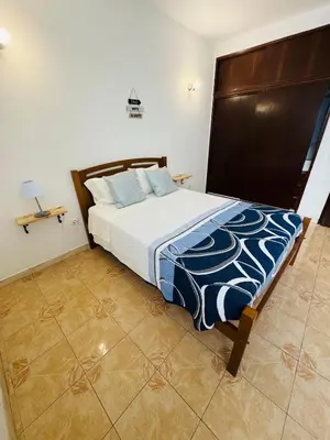 a bedroom with a large bed with blue pillows at Apartment old town MFA in Albufeira