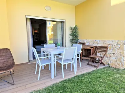 a white table and chairs on a deck at Albufeira Prime Apartment in Albufeira