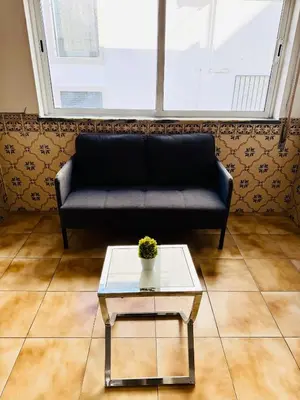 a couch in a living room with a coffee table at Apartment Old Town Telheiros in Albufeira