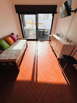 a living room with a couch and a sink at Apartment Old Town Ferreira de Castro in Albufeira
