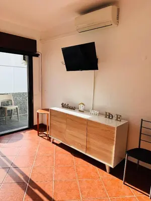 a living room with a flat screen tv on the wall at Apartment Old Town Ferreira de Castro in Albufeira