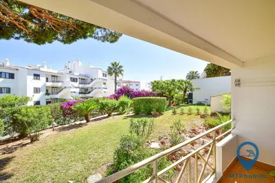 a bedroom with a large white bed with a couch at Estúdio Solar B by MTPhomes in Albufeira