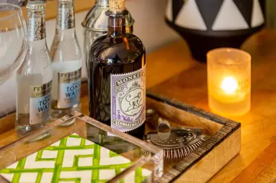 a bottle of wine sitting on a table with a candle at Victory Beach House in Quinta do Lago