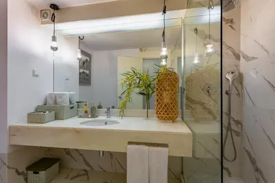 a bathroom with a sink and a mirror at Victory Beach House in Quinta do Lago