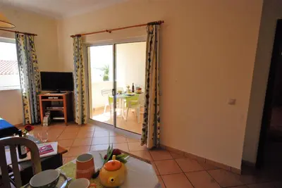 a living room with a sliding door to a dining room at VILLA EBER - independent 1 & 2 bedroom apartments, pool, air con, fast Wi-Fi, near old town of Albufeira and beaches in Albufeira