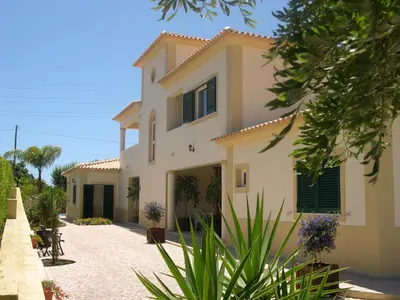 a large house with a driveway in front of it at VILLA EBER - independent 1 & 2 bedroom apartments, pool, air con, fast Wi-Fi, near old town of Albufeira and beaches in Albufeira