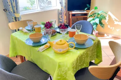 a green table with a teapot on top of it at VILLA EBER - independent 1 & 2 bedroom apartments, pool, air con, fast Wi-Fi, near old town of Albufeira and beaches in Albufeira