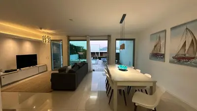 a living room with a table and a dining room at Albuhera - Private Pool - 8 Pax - Albufeira in Albufeira