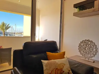 a black chair in a living room with a window at Marina Plaza 162 - Clever Details in Vilamoura
