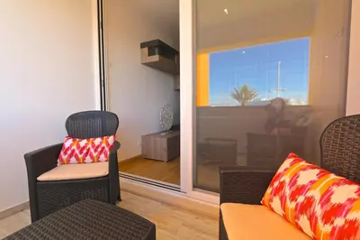 a living room with a chair and a couch and a window at Marina Plaza 162 - Clever Details in Vilamoura