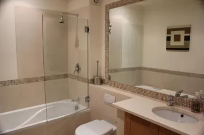 a bathroom with a tub and a sink and a toilet at Luxury 3 Bedroom Apartment on Gated Complex in Quarteira