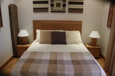 a bedroom with a large bed with two lamps at Luxury 3 Bedroom Apartment on Gated Complex in Quarteira