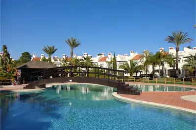 a bridge over a swimming pool at a resort at Luxury 3 Bedroom Apartment on Gated Complex in Quarteira
