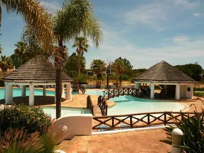 a pool at a resort with a gazebo at Luxury 2 Bedroom Apartment with Private Garden in Almancil