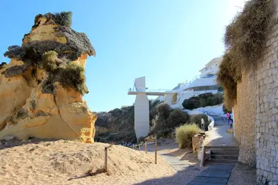 a cross on the side of a hill next to a rock at Cool Grey Albufeira in Albufeira