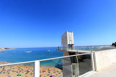 a view of the beach from the balcony of a building at Natural Grey Albufeira in Albufeira