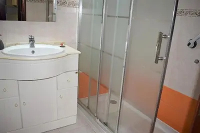 a bathroom with a sink and a shower at Quarteira Comfortable Apartment in Quarteira