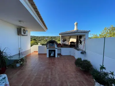 a patio with a pizza oven on a house at Casa #SerJo in São Brás de Alportel