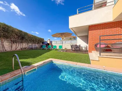 a swimming pool in front of a house at V3, Villa Jardins Branqueira6 near Beach, Albufeira in Albufeira