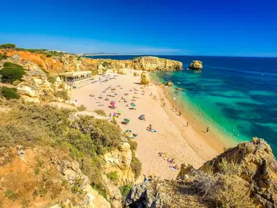 a group of people on a beach near the ocean at V3, Villa Jardins Branqueira6 near Beach, Albufeira in Albufeira